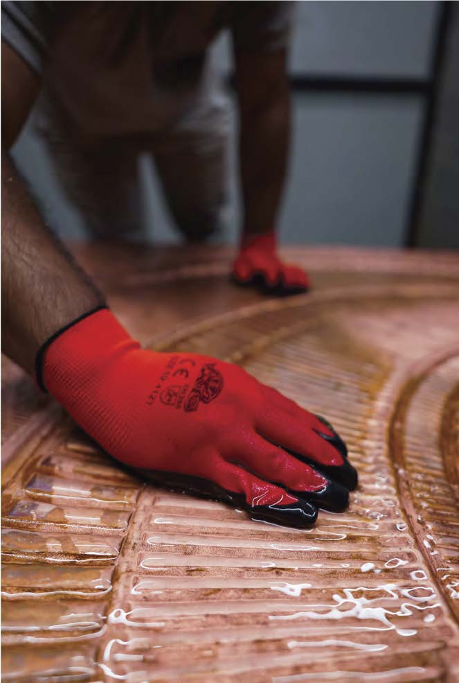 Craftsperson hand finishing a carved door