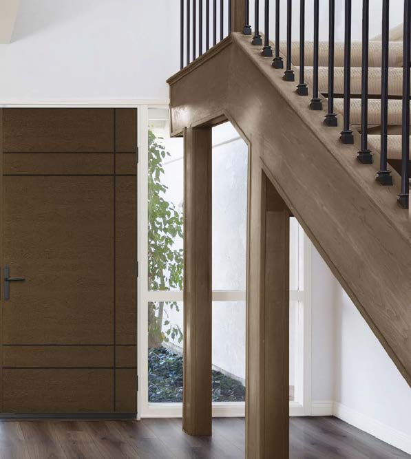 Walnut entrance door beside oak staircase